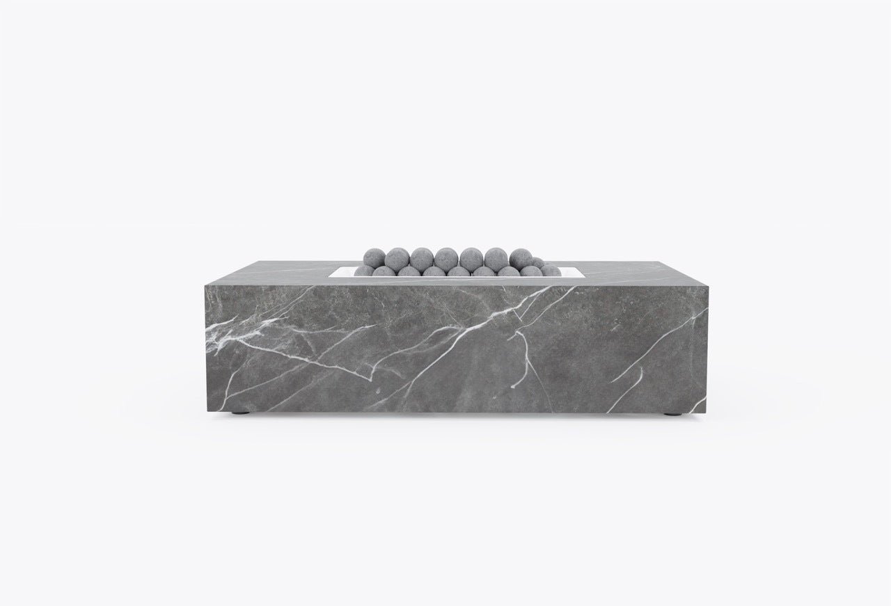 Outer OuterStone rectangular stone fire pit table in gray marble finish, front view, with lava rocks