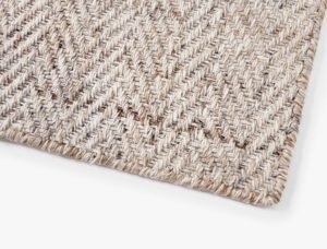 Eco-Friendly Outdoor Rug in Sand Dune Beige, corner closeup. Durable and sustainable outdoor rug made from recycled plastic bottles. #color_Sand Dune Beige