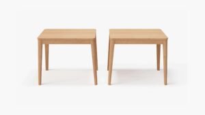 A set of two teak side tables with a natural wood finish, featuring round tops and three slightly tapered legs each, designed for versatile use beside sofas or chairs.-teak side table-outer #shape_rectangular
